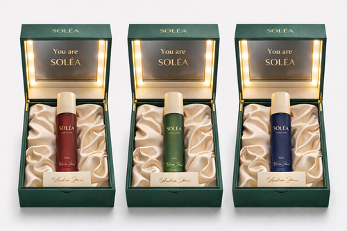 The VORÀ Imperial Collection: Three frosted cylindrical glass bottles with gold pumps sitting on dark marble. Blue (VORÀ), Green (SOLÉA), and Red (EMÁRA) hair elixirs.